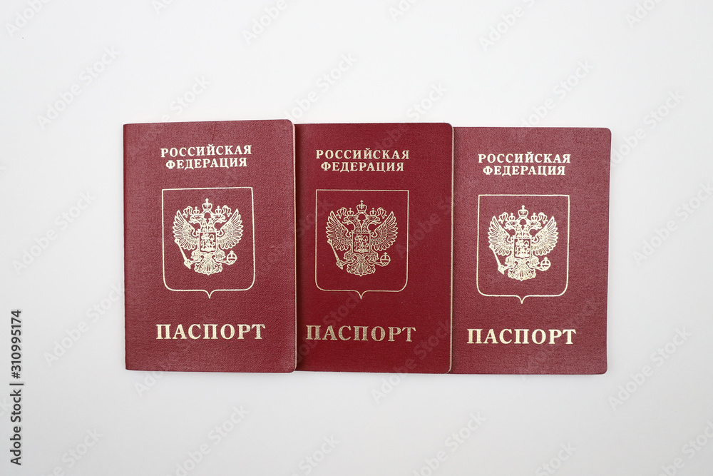 Three Russian passports on a white background. Three Russian passports on a white background.