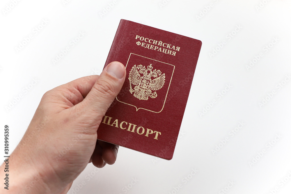 Hand with Russian passport on white background. Hand with Russian passport on white background.