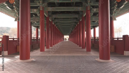 Scenic cinematic slow motion video of Woljeonggyo Bridge over Hyeongsan River in Gyeongju in South Korea. Beautiful summer cloudy look of colorful traditional asian style bridge in Republic of Korea. photo