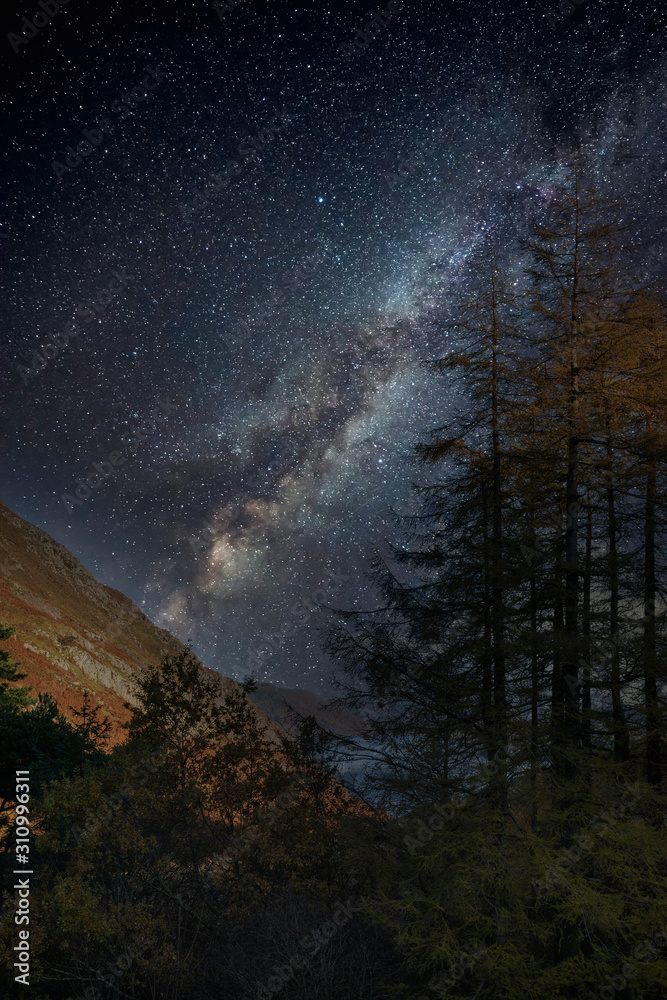 Stunning majestic digital composite landscape of Milky Way over Hallin Fell in Lake District