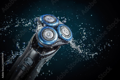Closeup of a beautiful electric razor with three round knives photo