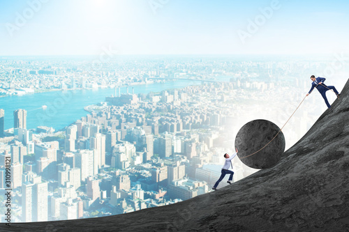 Bild auf Leinwand Teamwork example with business people pushing stone to top