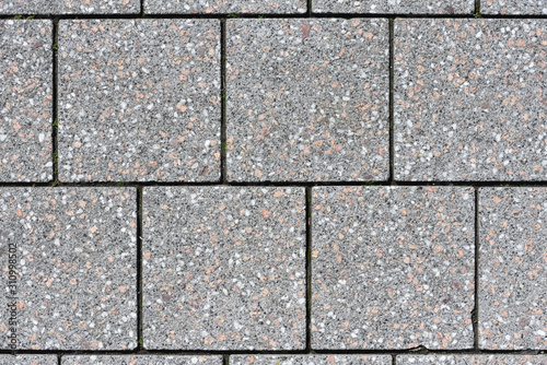 The texture of the square paving slabs of gray in a European city