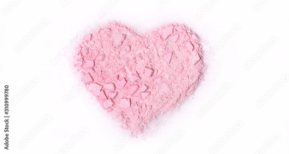 crumb of pink powder blush scattered in the shape of heart on white background, isolate, top view