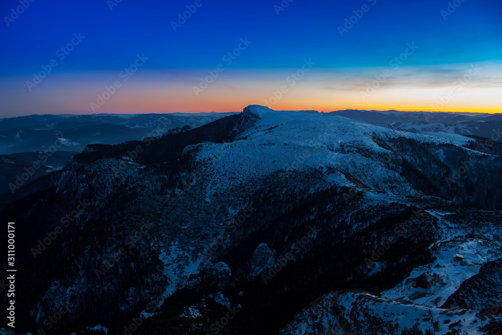 Ceahlau mountain landscape at sunset. winter scene, Romania
