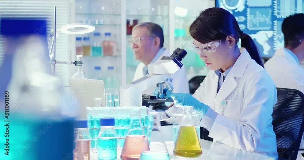 Asian scientist use microscope Asian scientist use microscope