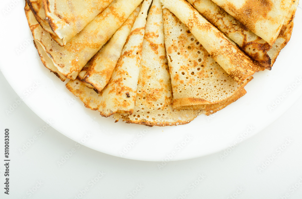 Russian style pancakes on a white plate studio shot Russian style pancakes on a white plate studio shot