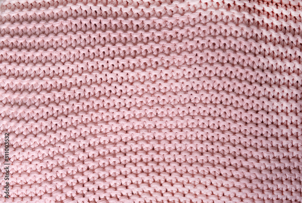 Texture pink knitted sweater. The concept of comfort and soft clothes. Knitting concept.
