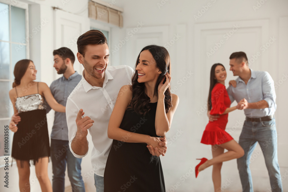 Lovely young couple dancing together at party