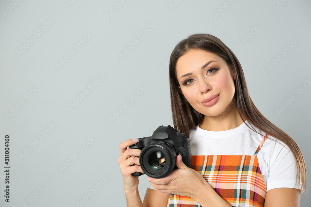 Professional photographer working on light grey background in studio. Space for text
