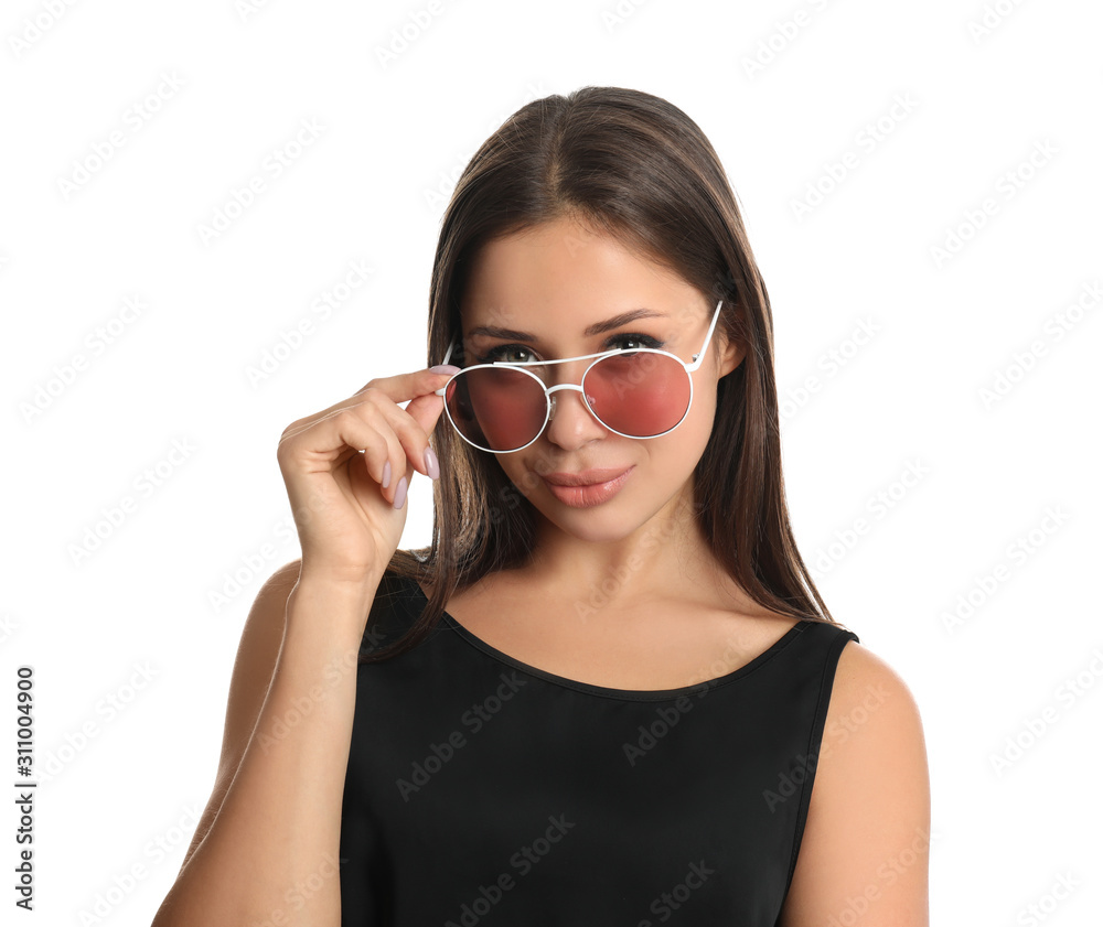 Beautiful young woman wearing sunglasses on white background