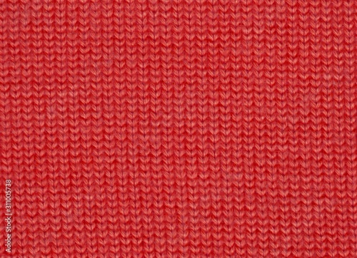 Red background.Knitted woolen texture background.Hand-made knit sweater pattern.Textile woolen banner structure.Merry christmas.Happy New Year.Winter holidays.