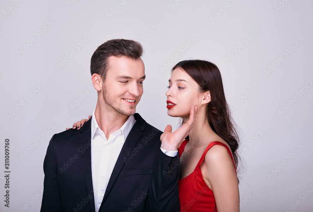 Beautiful young couple smiling, standing face to face on the background. Beautiful young couple smiling, standing face to face on the background.
