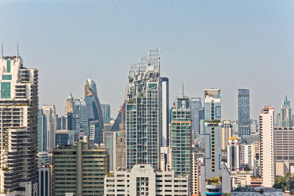 Obraz premium Bangkok, Thailand – December 22, 2019 : Office Buildings, city and condominiums Area in Bangkok, Office Building in City, Modern Building, Businesses Building. Sky view from Asoke area. with blue sky.