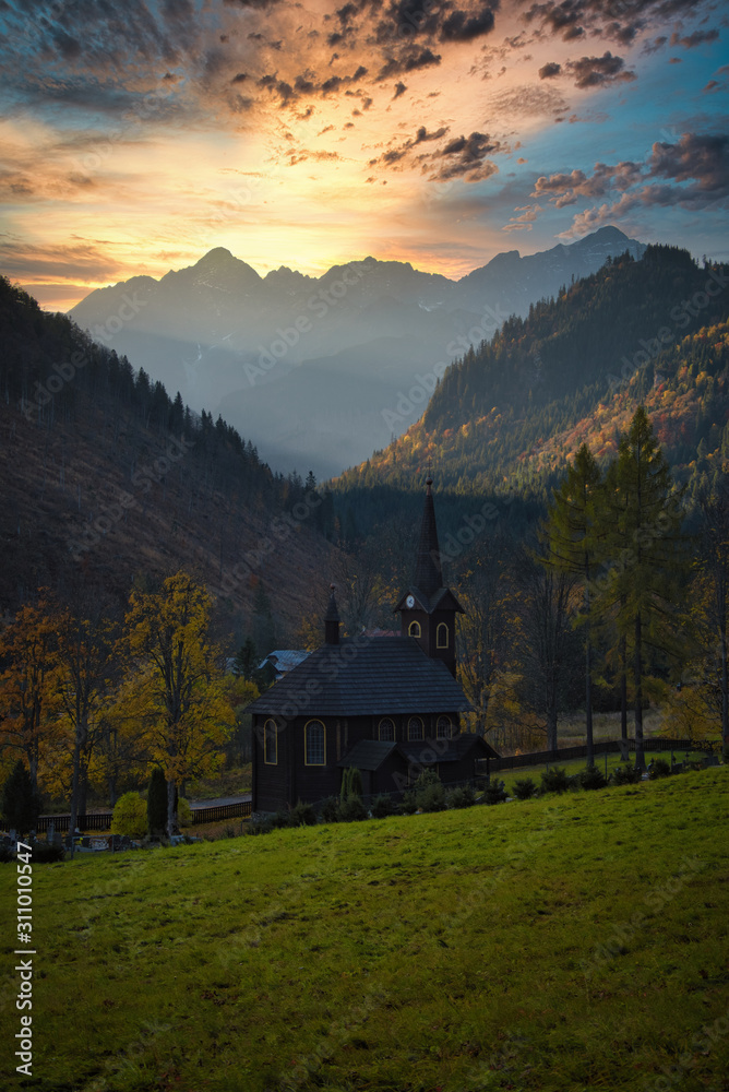 Old wooden churn in mountain valley at sunrise, High Tatras Slovakia Tatranska Javorina