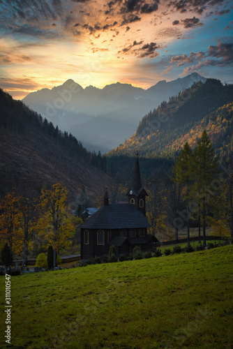Fototapeta Naklejka Na Ścianę i Meble -  Old wooden churn in mountain valley at sunrise, High Tatras Slovakia Tatranska Javorina