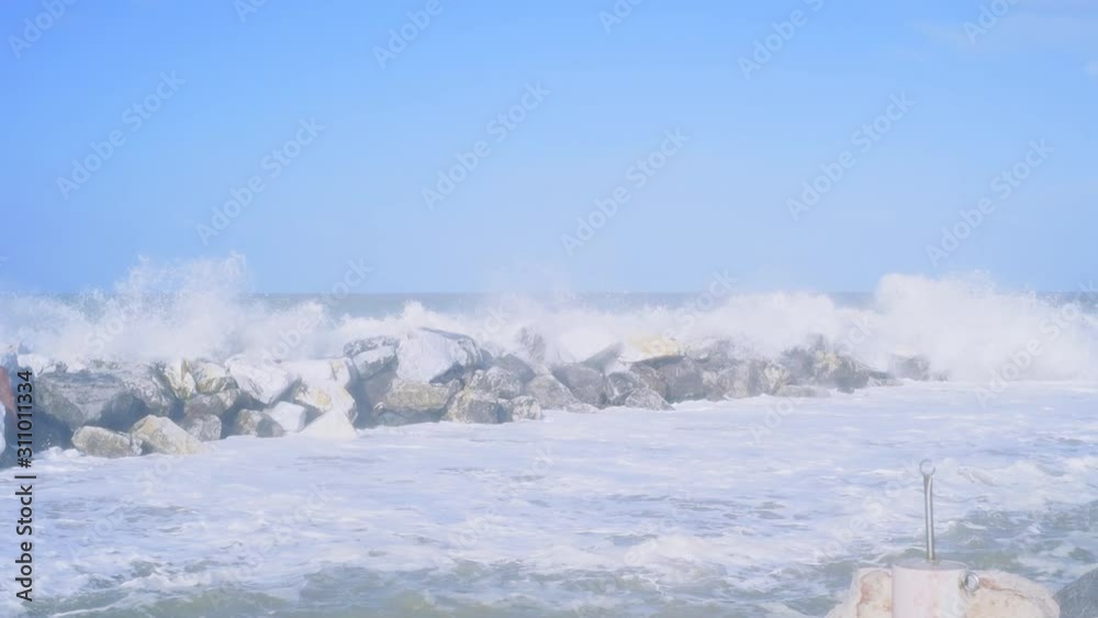 Slow motion splashes big strong waves crashing on the pier. Motion wave with splashes Slow motion splashes big strong waves crashing on the pier. Motion wave with splashes
