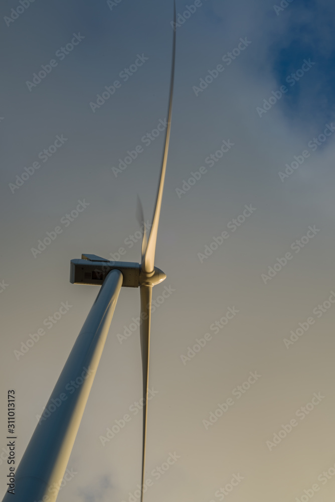 Windmill photographed from below with a cloudy sky as background Windmill photographed from below with a cloudy sky as background