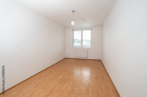 empty room with wooden floor and walls