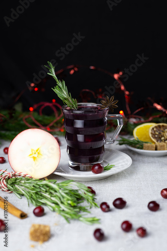 warming spiced wine in a glass with berries, spices and rosemary