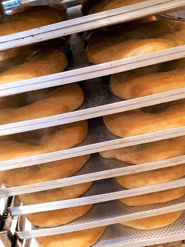 close-up of freshly baked flour pastries on a rack, soft hot tortillas / bread in a bakery