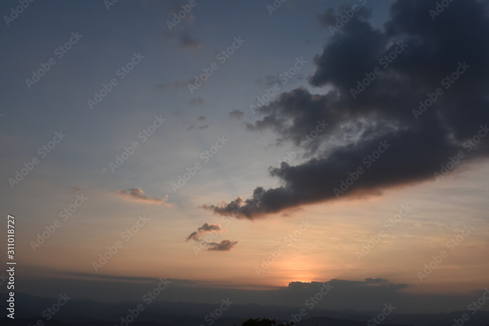 Morning clouds with the sunrise on foggy landscape