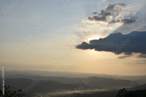 Morning clouds with the sunrise on foggy landscape © Sophon_Nawit