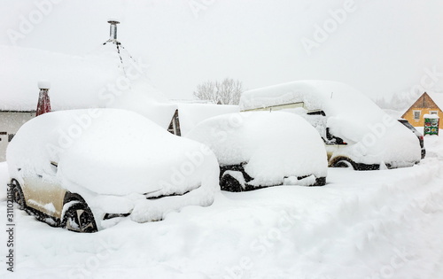 cars transport parking winter covered in snow stuck, snowfall cold climate weather © Shevdinov