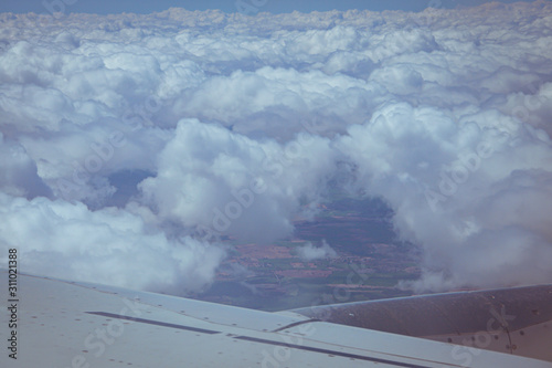Views of the earth between clouds from an airplane