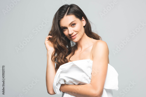 portrait of positive beautiful girl with perfect skin, isolated on grey