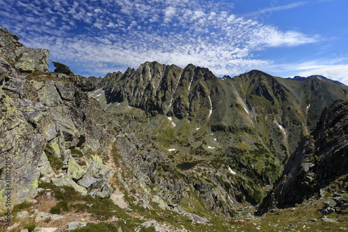 Rocky mountain ridge with little clouds.