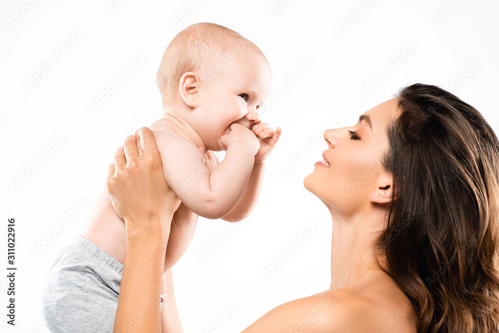 portrait of nude happy mother looking at baby, isolated on white portrait of nude happy mother looking at baby, isolated on white