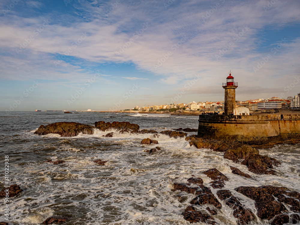 Porto, Portugal. 16 November 2019. Felgueiras Lighthouse standing on a quay at the stormy Atlantic coast off Porto on a sunny autumn day.