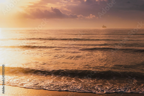 Calm sea waves in golden light in Larnaca photo