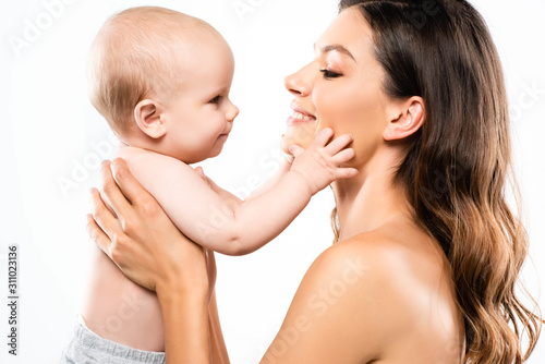 portrait of positive naked mother holding baby, isolated on white