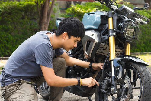 Mechanic fixing motocycle worn motorcycle drum breaks shoes. Professional training, repairing motorbike.