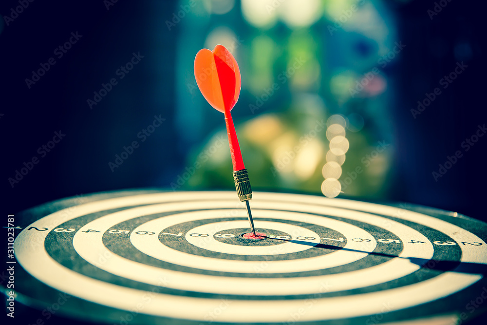 Close up red color arrow in the center of Bullseye concept of business goal and capability. Close up red color arrow in the center of Bullseye concept of business goal and capability.