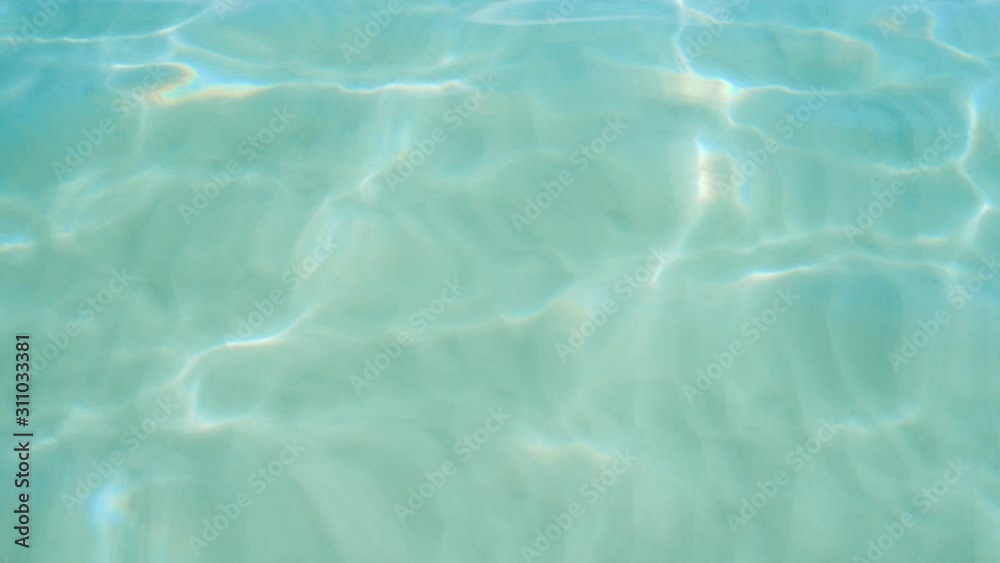 Pure blue water in the Pacific Ocean with light reflections. Slow motion.