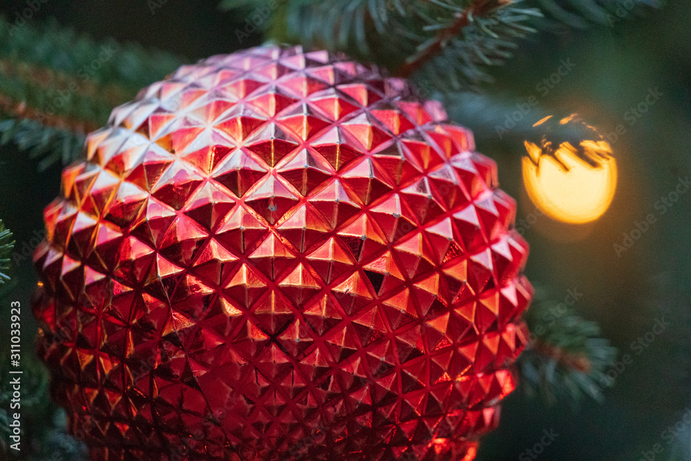 Fototapeta premium Red Geodesic Christmas Tree Ornament Close Up with Background Lights