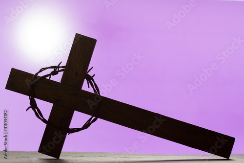 Wall Mural Abstract easter wooden cross and crown of thorns on purple background