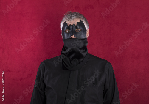Fototapeta Naklejka Na Ścianę i Meble -  man in bat mask on a red background