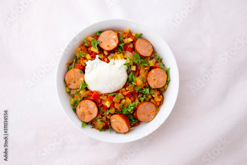 Spanish dish pisto manchego with chorizo sausages and poached egg