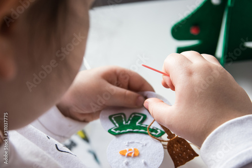 Child make snowmans for christmas. photo