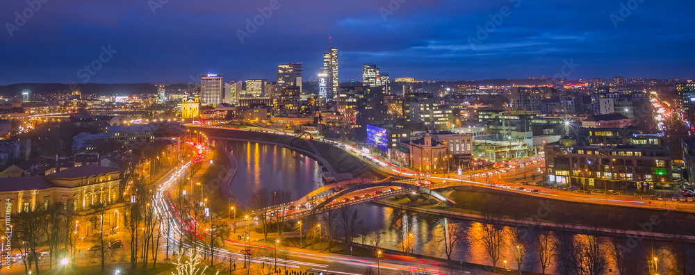 Naklejka premium Vilnius city with glowing buildings in the evening light
