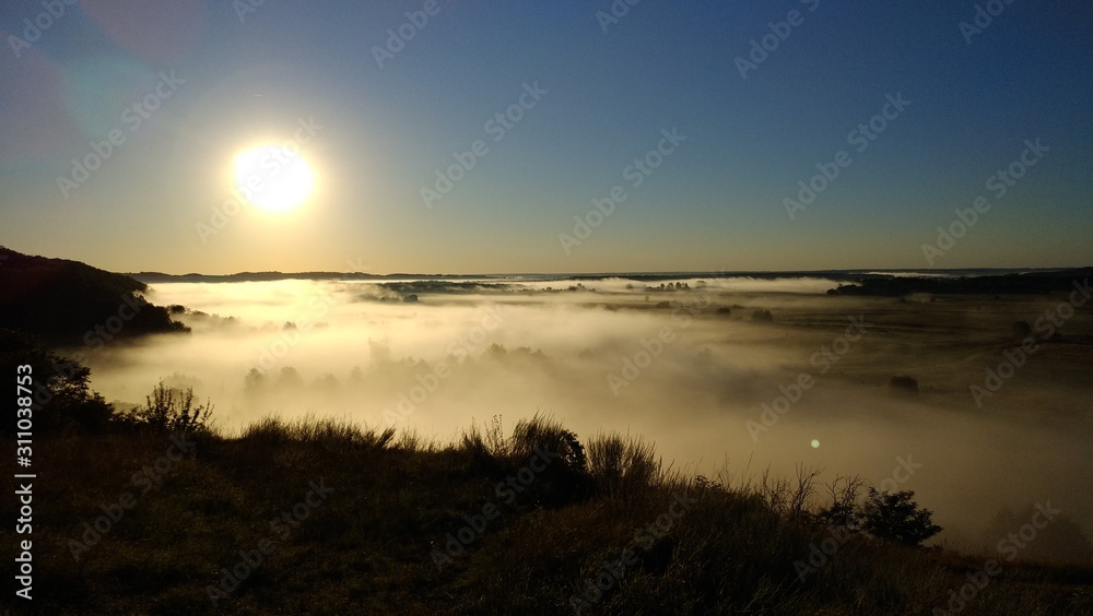 Sunrise over the misty valley