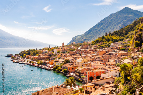 Limone Sul Garda cityscape on the shore of Garda lake surrounded by scenic Northern Italian nature. Amazing Italian cities of Lombardy #311040397