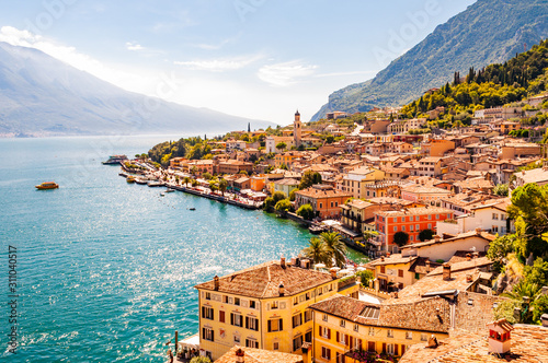 Fototapeta Limone Sul Garda cityscape on the shore of Garda lake surrounded by scenic Northern Italian nature