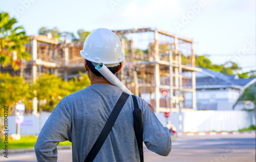 Engineer who is see plan to oversee construction site