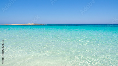 Fototapeta Naklejka Na Ścianę i Meble -  Marsa Matruh, Egypt. The sandy beach and the amazing sea with tropical blue, turquoise and green colors. Relaxing context. Fabulous holidays. Mediterranean Sea. North Africa. Clean and pristine sea