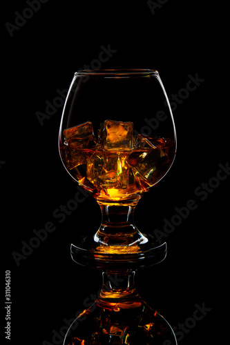glass of scotch whiskey with ice